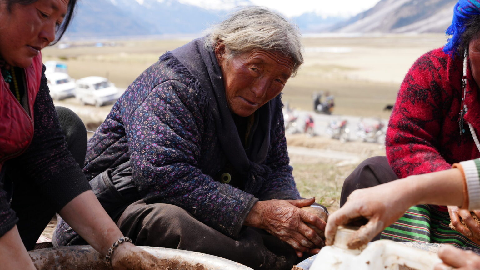Locals forming clay figures